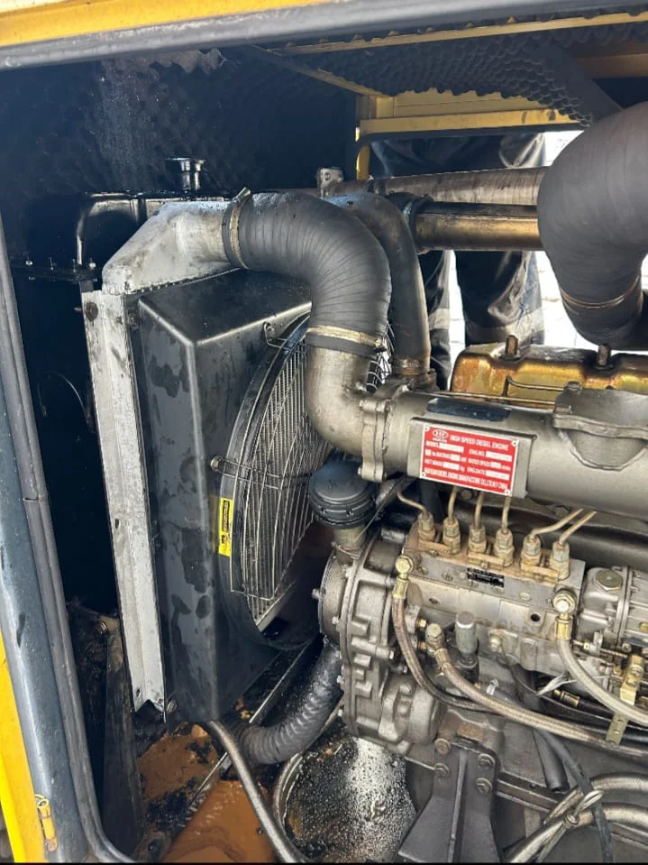 Industrial generator repair technician working on machinery